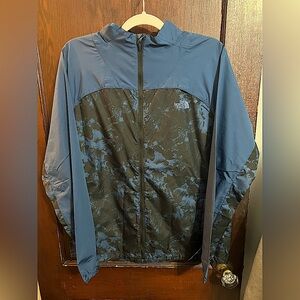 The North Face blue and black camouflaged large windbreaker